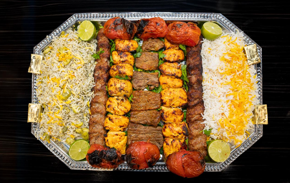 Assorted Persian kabob catering platter with koobideh, chicken, and chenjeh served at Aban Restaurant
